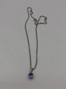 An 18ct white gold necklace with a sapphire pendant