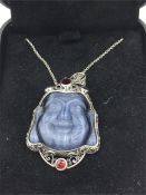 An unusual silver Abalone Pendant necklace in the form of a Budha inset with rubies