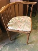 A corner chair with pillar back and floral seat pad