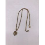 An 18ct gold chain with a 15ct gold pendant (3.7g and 1.5g)