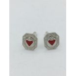 A pair of silver cufflinks set with enamel hearts
