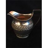 A silver milk jug, hallmarked Sheffield 1896, makers mark HA (130g)