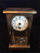 A Brass mantle clock with enamel face