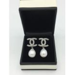 A Pair of silver and freshwater pearl drop earrings in the designer style