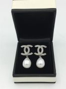 A Pair of silver and freshwater pearl drop earrings in the designer style