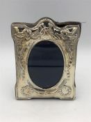 A hallmarked silver photo frame with decorative surround