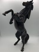 A figure of a rearing horse