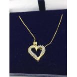 A 14ct yellow gold heart shaped diamond set pendant necklace on gold chain