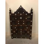 A Persian carved screen with mother of pearl inlay.