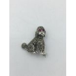 A silver Marcasite Poodle Brooch with ruby eyes