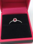 An 18ct white gold ruby and diamond cluster ring