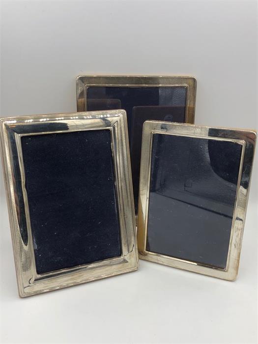Three assorted silver photo frames