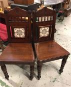 A Pair of Victorian hall chairs with tiled inset