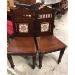 A Pair of Victorian hall chairs with tiled inset