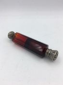 A ruby glass scent bottle with silver caps