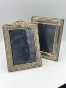 A pair of silver photograph frames.