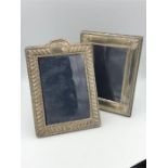 A pair of silver photograph frames.