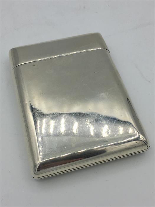 A silver cigarette case, built in match striker, makers mark SM Hallmarked London 1883/84