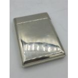 A silver cigarette case, built in match striker, makers mark SM Hallmarked London 1883/84