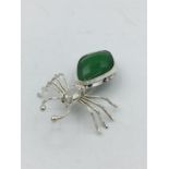 A silver and jade spider brooch