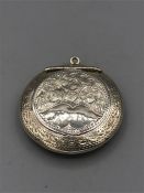 A silver locket, hallmarked Birmingham 1918