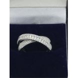 An impressive 18ct white gold diamond cross over ring of 75 points