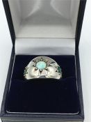 A silver emerald and opal ring