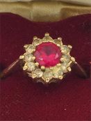 A 9ct gold ring with ruby and diamonds in a heart shaped box