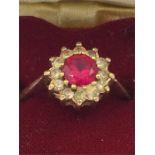 A 9ct gold ring with ruby and diamonds in a heart shaped box