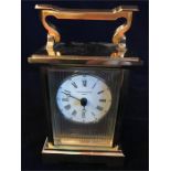 A Carriage Clock in brass with a hallmarked silver face. Rency Anglaise by Taylor Bligh No 10 of a
