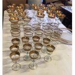 A large selection of gold edged glasses to include champagne, wine, sherry, liqueur, water and a