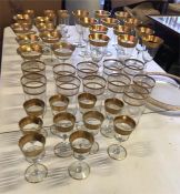 A large selection of gold edged glasses to include champagne, wine, sherry, liqueur, water and a