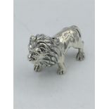 A cast silver figure of a lion