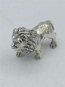 A cast silver figure of a lion