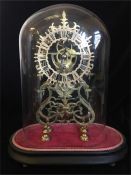 A Skeleton clock under a glass dome.