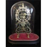A Skeleton clock under a glass dome.