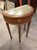 A marble topped half moon hall table