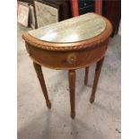 A marble topped half moon hall table