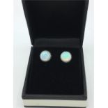 A pair of silver and opal stud earrings