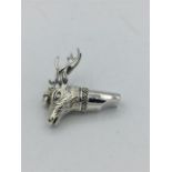 A silver whistle in the form of a stag.