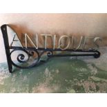 A wrought Iron Antiques Shop sign