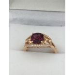 A 14ct Rose Gold Garnet and white Sapphire ring