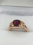 A 14ct Rose Gold Garnet and white Sapphire ring