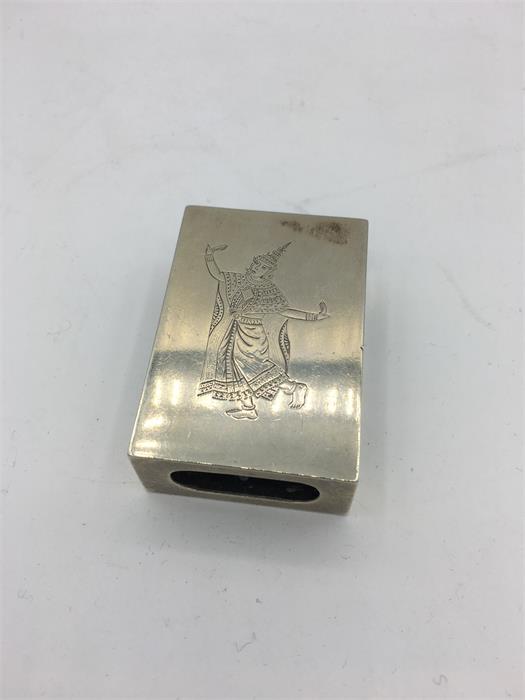 A white metal matchbox holder