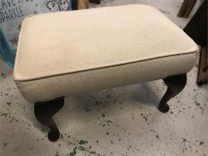 A cream foot stool