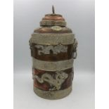 An Oriental copper lidded jar with dragon relief.