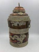 An Oriental copper lidded jar with dragon relief.