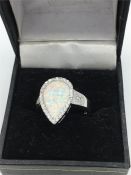 A silver and opal heart shaped ring