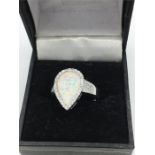 A silver and opal heart shaped ring