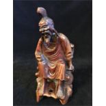 A carved redwood seated Chinese immortal (19cm)